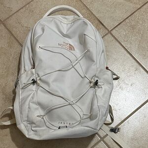 The North Face white and rose gold Jester backpack with laptop padded sleeve.
